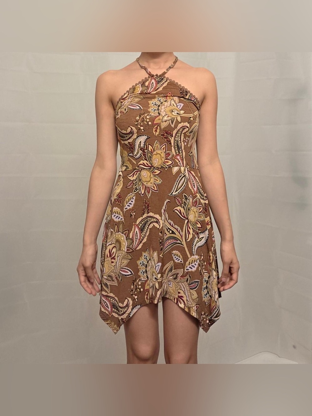 Brown paisley and floral print mini dress with halter neck and handkerchief hem